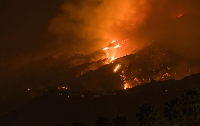 The La Tuna Canyon fire burns in the hills above Burbank, California, early September 2, 2017. 
The brush fire which quickly burned 2,000 acres started on September 1 and was being driven by heat wave temperatures and high winds.   / AFP PHOTO / Robyn Beck        (Photo credit should read ROBYN BECK/AFP/Getty Images)