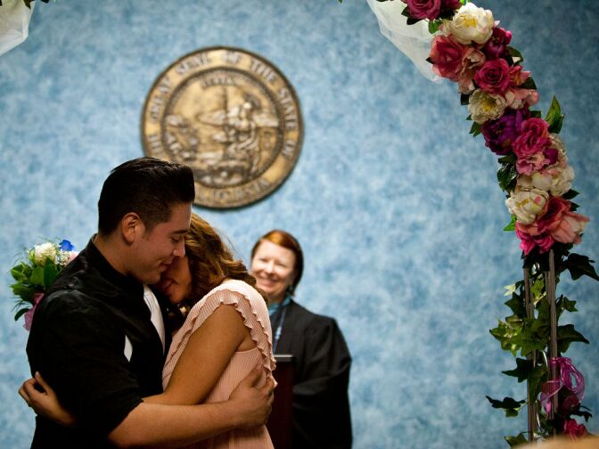 Rick and Jessica Garcia embrace after the two are married.