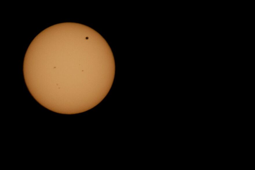 Venus passes in front of the sun as it makes its transit.