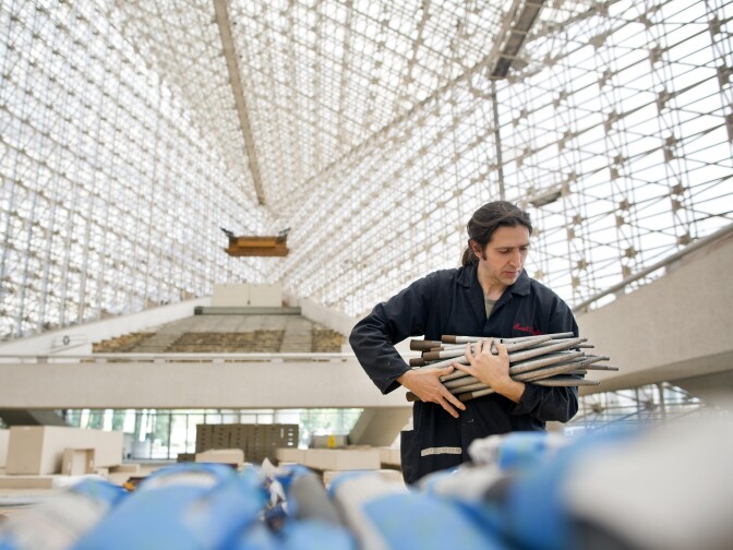 Franco Martin, an employee of the Fratelli Ruffatti organ company in Italy, gathers parts for packaging to be shipped to the company's factory.