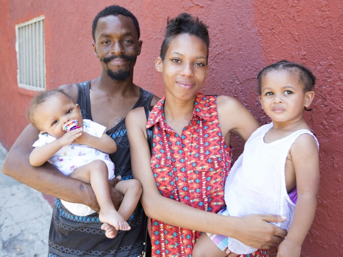 Stephanie Williams, 20, her partner Robery Lewis, 27, with baby Rieley Lewis, 9 months, and daughter Kylee Lewis, 2, outside their apartment in City West, Los Angeles on 20th June 2016. Stephanie earned her high school diploma this June through Project NATEEN at Children's Hospital Los Angeles. 