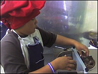 10-year-old Hubert Dayish, vice president of sales and marketing for Lickety Split Chocolate, melts chocolate to use for candies.