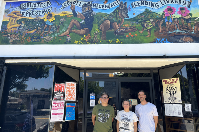 Coyotl+Macehualli co-founders Brenda Contreras and Micah Haserjian stand next to local artist Pavel Acevedo outside the lending library on Eastern Avenue in El Sereno.