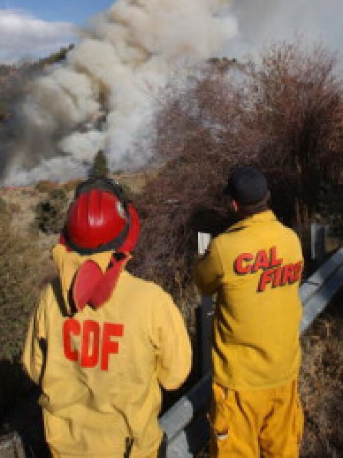 Firefighters for Cal Fire watch for hot spots. If a pension rollback deal is accepted, new firefighter hires would have to wait 5 years longer to retire. 