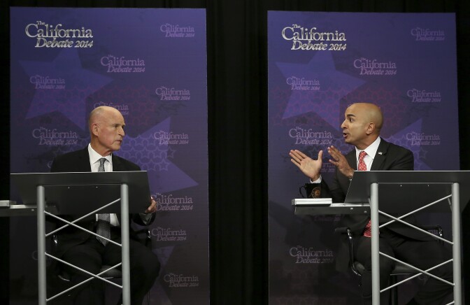Gov. Jerry Brown, left, listens as Republican challenger Neel Kashkari speaks during a gubernatorial debate in Sacramento, Calif., Thursday, Sept. 4, 2014. Thursday's debate is likely to be the only one of the general election. (AP Photo/Rich Pedroncelli, Pool)
