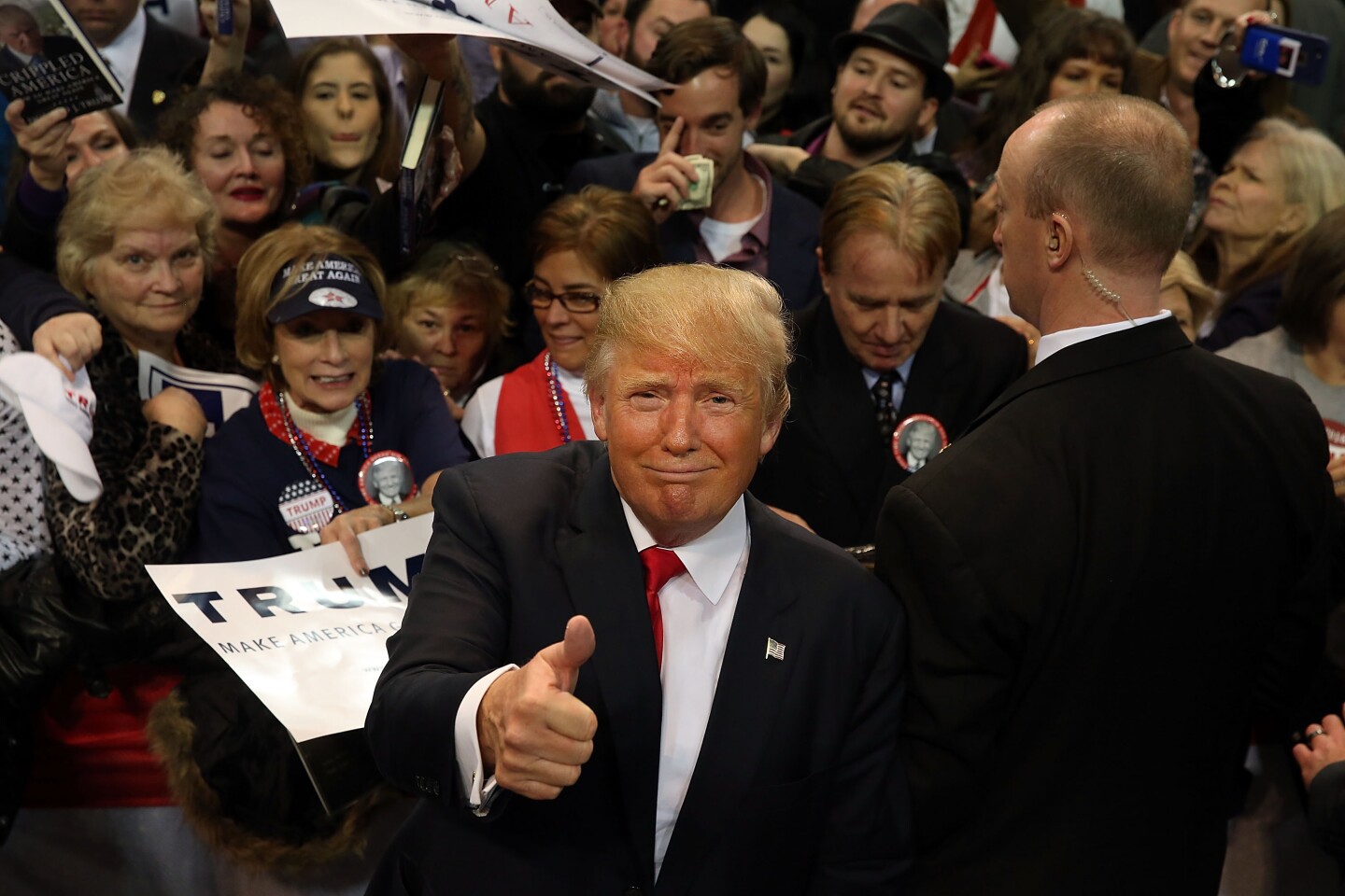 Republican presidential frontrunner Donald Trump pauses with supporters after speaking at the Mississippi Coast Coliseum on Jan. 2, 2016 in Biloxi, Mississippi. 