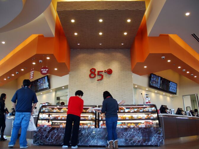 WEST COVINA, Calif. -- Customers gather around the dessert case at the new 85°C Bakery Cafe on Jan. 16. This company-owned West Covina location is the third to open in the United States, with more openings planned throughout Southern California. The Taiwan-based chain, while new to the U.S. market, operates more than 700 stores worldwide.
