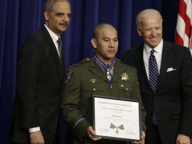 Vice President Joe Biden and Attorney General Eric Holder present the Medal of Valor to Officer Rafael Rivera of the California Highway Patrol, Wednesday, Feb. 20, 2013, during a ceremony in the Eisenhower Executive Office Building on the White House complex in Washington. The medal is the highest national award for valor by a public safety officer. The medal is awarded to public safety officers who have exhibited exceptional courage, regardless of personal safety, in the attempt to save or protect human life.  
