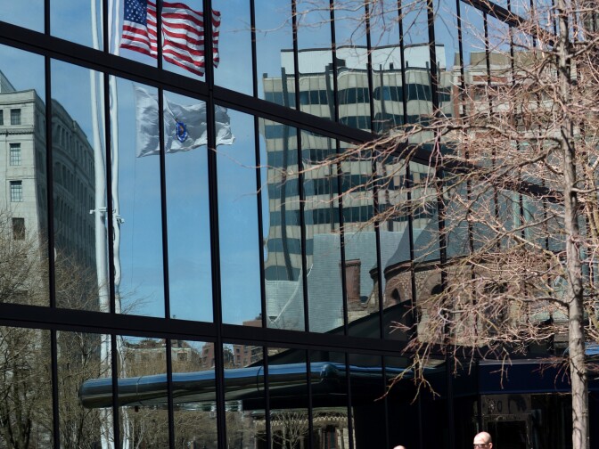 Flags flying at half staff are reflected in a glass office building April 16, 2013 in Boston, Massachusetts, in the aftermath of two explosions that struck near the finish line of the Boston Marathon on Monday. As a mark of respect for the victims, President Barack Obama issued a proclamation that the flag of the United States shall be flown at half-staff at the White House and upon all public buildings and grounds throughout the United States and its Territories and possessions until sunset, April 20, 2013.
