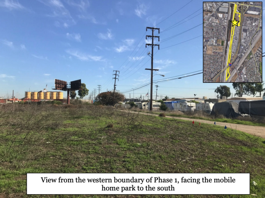 A field full of tumbleweeds sits in front of a path with a fence marking a mobile home park. In the top right corner is a map showing the location in South Gate