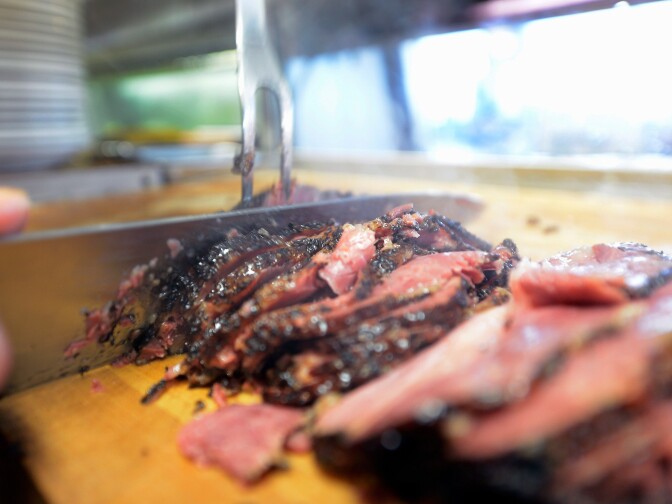 LOS ANGELES, CA - FEBRUARY 26:  An employee at Langer's Delicatessen slices pastrami on February 26, 2013 in Los Angeles, California. According to a report, America's Jewish delis are struggling to stay afloat. There were several thousand Jewish delis open in New York City during the first half of the 20th century, now there are only a few dozen.  (Photo by Kevork Djansezian/Getty Images)