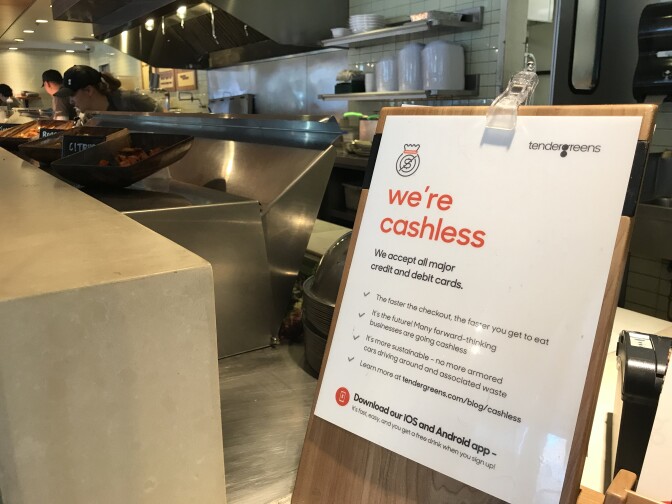 Signs throughout Tender Green's location in Pasadena warn customers not to try to pay with cash once they get to the register, March 28, 2018. 