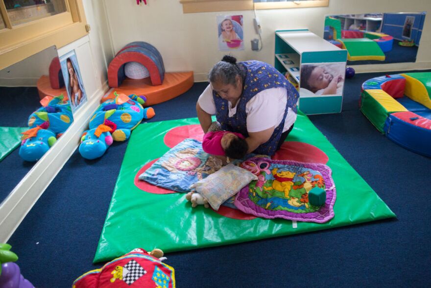 Rosa Sanchez lays a child down to rest at Jardín de Niños, which is part of the California Children's Academy that helps families become financially independent by providing affordable child care to low income families.