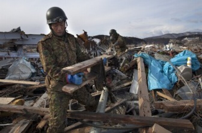 Members of Japan's Self-Defense force clear debris as they continue searching for bodies.
