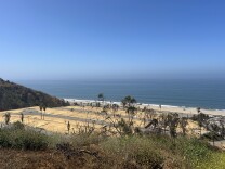 A shot of empty dirt lots of a former mobile home park overlooking the Pacific Ocean in Pacific Palisades on a sunny day. 
