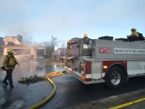 Firemen put out a fire at a home in the Anaheim Hills neighborhood on October 9, 2017, after the Canyon Fire 2 spread quickly through the area.