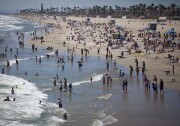 Huntington Beach is busy with beachgoers on a recent afternoon. The beach will host the U.S. Open of Surfing starting Saturday.