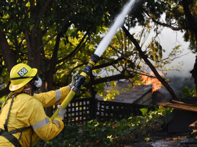 A firefighter battles the Skirball Fire in Bel Air, California on December 6, 2017.