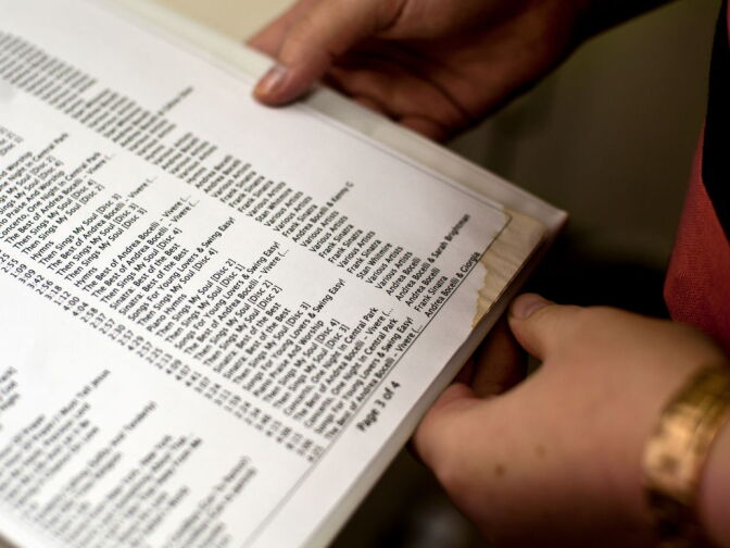 Jessica Litchfield, director of residential activities and volunteers, opens a binder full of residents' customized playlists. Through speaking with spouses and family members, Litchfield gathered music from each residents' past.
