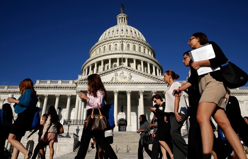 Tourists walk past the U.S. Capitol as the Congress remains gridlocked over legislation to continue funding the federal government September 30, 2013 in Washington, DC. The House of Representatives passed a continuing resolution with language to defund U.S. President Barack Obama's national health care plan two days ago, but Senate Majority Leader Harry Reid has indicated the U.S. Senate will not consider the legislation as passed by the House.  