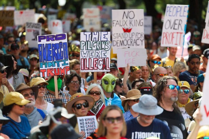 One sign reads: The pilgrims were illegal