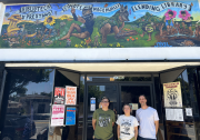 Coyotl+Macehualli co-founders Brenda Contreras and Micah Haserjian stand next to local artist Pavel Acevedo outside the lending library on Eastern Avenue in El Sereno.
