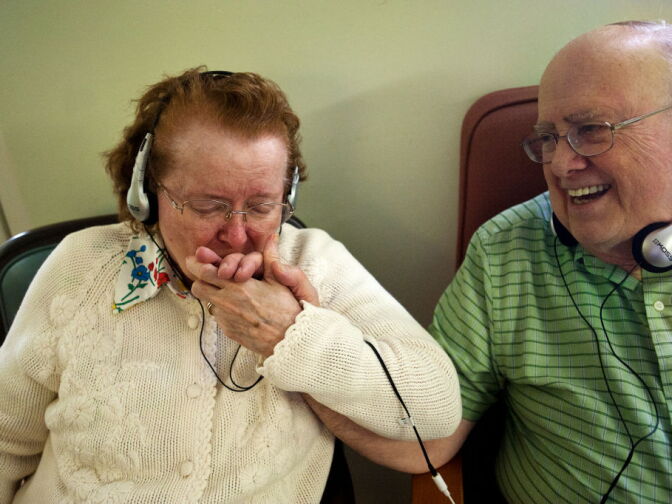 Marcie, 85, and Tom H., 84, listen to music from an iPod on Thursday, Jan. 24 at Atherton Baptist Homes in Alhambra. Marcie is one of several residents with dementia who is part of Atherton's Music & Memory program.