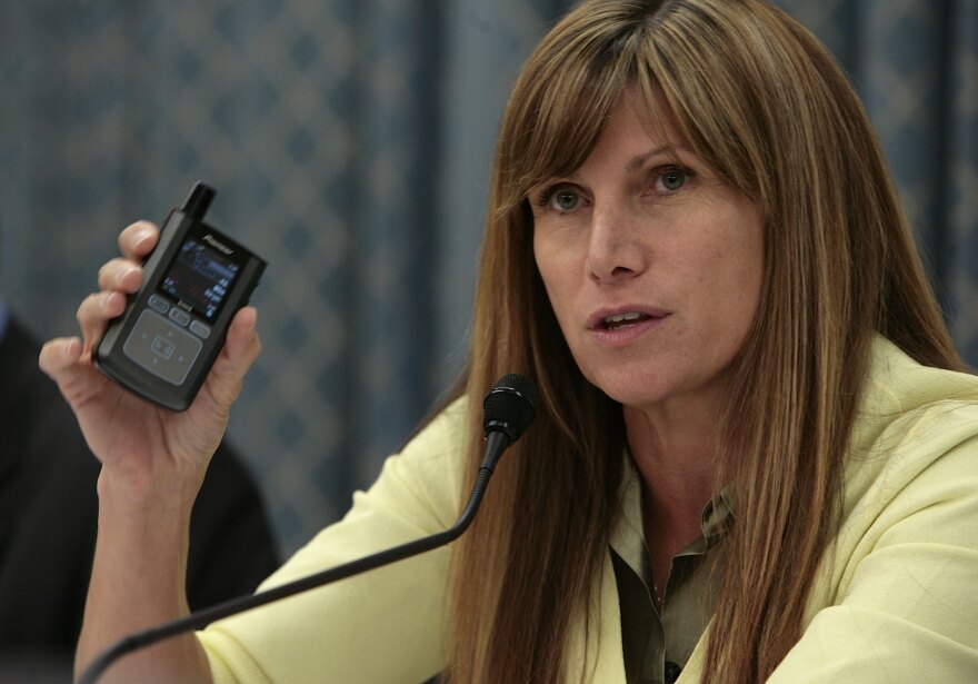 File: Mary Bono (R-CA) holds a pocket-sized XM Radio receiver while questioning witnesses on Capitol Hill May 3, 2006 in Washington, DC.