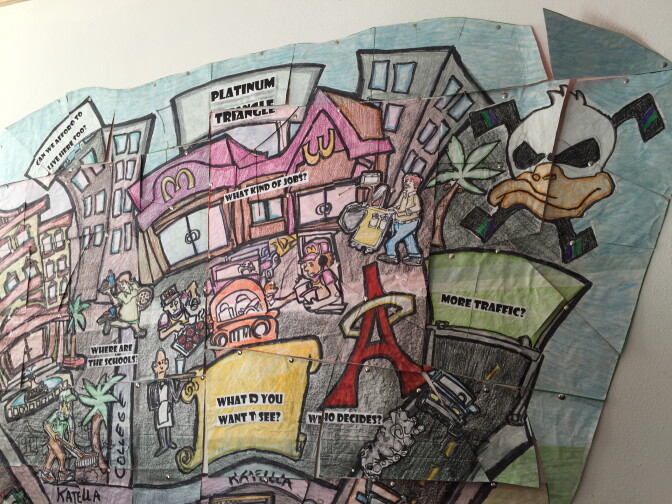 A puzzle-piece cartoon mural of the city of Anaheim hangs on the entrance of the OCCORD office. The Orange County community-organizing has participated in the redistricting process. 