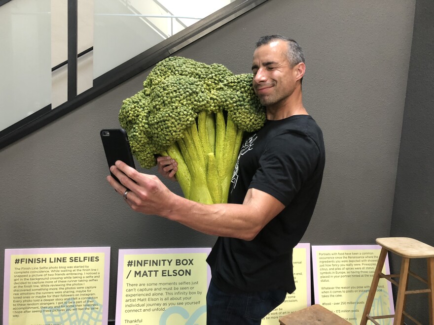 Food selfies are a big part of the selfie culture. A Martinez takes a selfie with some cuddly broccoli.