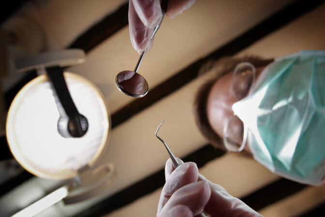 GREAT BOOKHAM, UNITED KINGDOM - APRIL 19:  A patients eye view, as a dentist poses for the photographer on April 19, 2006 in Great Bookham, England.  (Photo by Peter Macdiarmid/Getty Images)