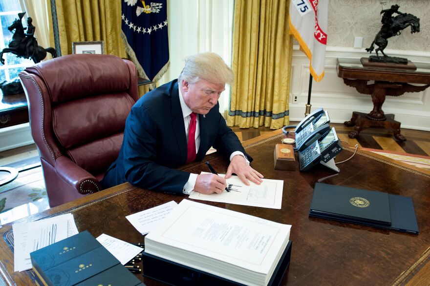 United States President Donald J. Trump signs the Tax Cut and Reform Bill in the Oval Office at The White House in Washington, DC on December 22, 2017.  / AFP PHOTO / Brendan Smialowski        (Photo credit should read BRENDAN SMIALOWSKI/AFP/Getty Images)