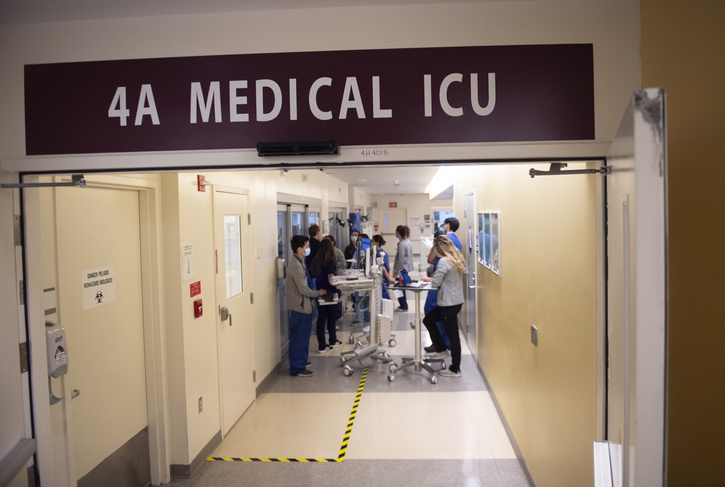 An image of hospital workers in a hallway of an intensive care unit.