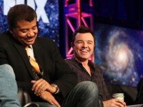 PASADENA, CA - JANUARY 13: Neil DeGrasse Tyson (L) and executive producer Seth MacFarlane speak during the FOX portion of the 2014 Television Critics Association Press Tour at the Langham Hotel on January 13, 2014 in Pasadena, California.  (Photo by Frederick M. Brown/Getty Images)