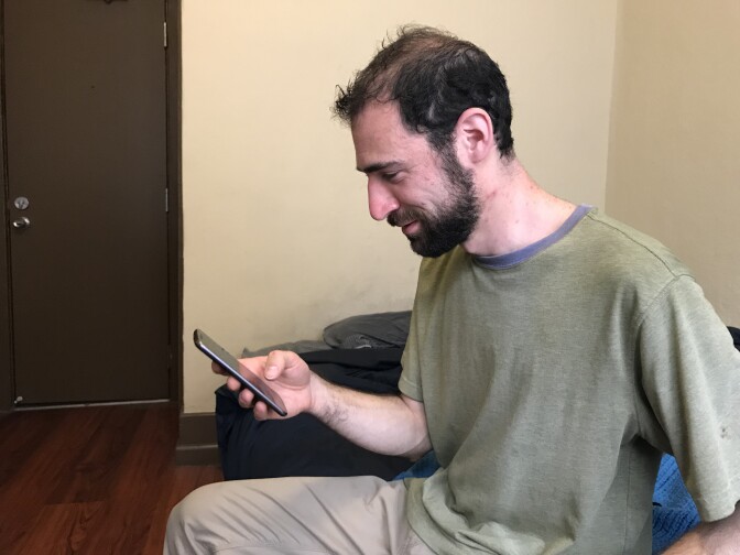 Downtown Los Angeles Target employee Justin Orkin checks his work schedule on a smartphone app, March 13, 2018. 