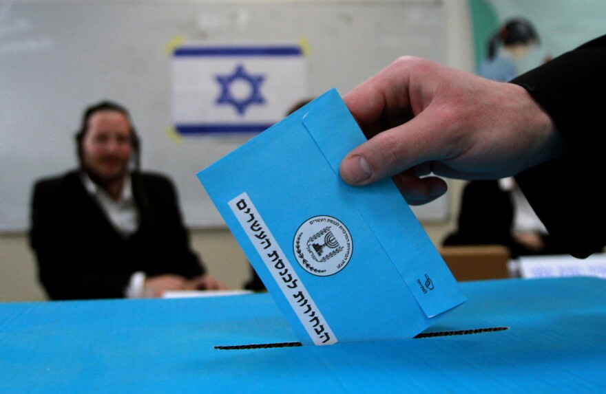 An Israeli ultra-orthodox Jewish man casts his ballot at a polling station in Bnei Brak, near the city of Tel Aviv, on March 17, 2015. Israelis are voting in a close-fought election pitting the centre left against Prime Minister Benjamin Netanyahu, who ruled out a Palestinian state in a last-ditch appeal to the far-right. AFP PHOTO / GIL COHEN-MAGEN        (Photo credit should read GIL COHEN MAGEN/AFP/Getty Images)