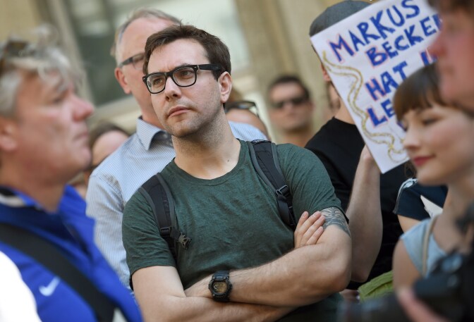 FILES - US journalist and internet activist Jacob Appelbaum attends a demonstration in support of freedom of press on August 1, 2015, in Berlin as reaction to treason investigation against two writers of the news blog Netzpolitik. A clash between Germany's chief prosecutor and justice minister broke into the open on August 4, 2015, sparked by a treason probe against a blog that had published domestic security documents. The case centres of the blog Netzpolitik.org (Net politics), which earlier his year published documents on plans by Germany's domestic security agency to step up Internet surveillance.  AFP PHOTO / DPA / BRITTA PEDERSEN +++ GERMANY OUT        (Photo credit should read BRITTA PEDERSEN/AFP/Getty Images)