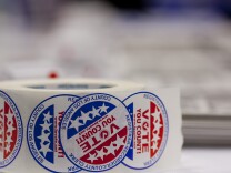 Volunteers gave about stickers to newly naturalized American citizens after they registered to vote.