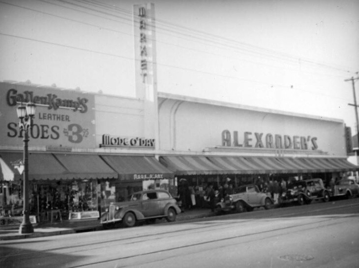 Black and white photo has the Alexander's store on the right, also pictured Mode O'Day and Gallen Kamp's.