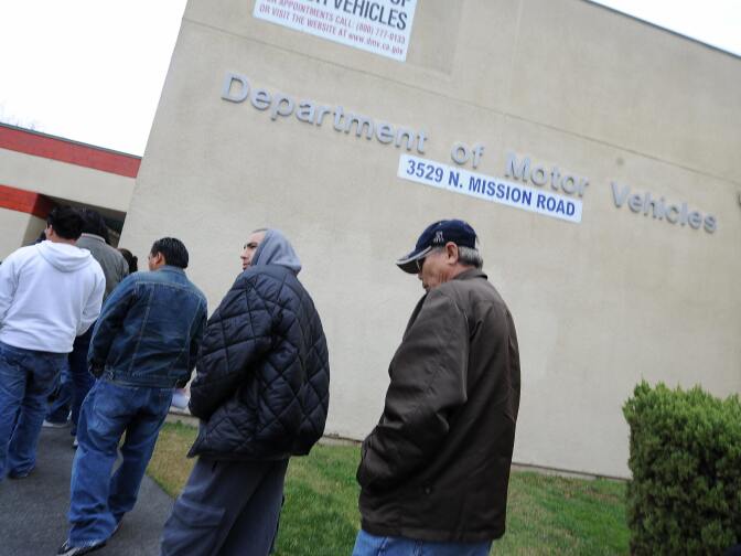 People wait in line outside of the State of California Department of Motor Vehicles (DMV) in Los Angeles, California on February 13, 2009.   The DMV, already infamous for long waiting times, is now further taxed as employees are off the job and the offices are closed two days a month as California government imposes its first-ever unpaid furlough to save money during the fiscal crisis.  The action is in connection with Schwarzenegger?s executive order that addresses the state?s 42 billion USD deficit and ongoing fiscal crisis.  Schwarzenegger has also threatened to lay off as many as 10,000 state employees if a new budget is not passed this week.  AFP PHOTO/ ROBYN BECK (Photo credit should read ROBYN BECK/AFP/Getty Images)