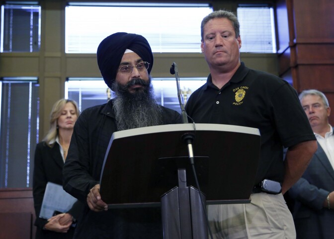 OAK CREEK, MI - AUGUST 6:  Oak Creek Police Chief John Edwards (R) along with a member of the Sikh Church names victims of the shooting at the Sikh Temple of Wisconsin where yesterday a gunman fired upon people at service, at a press conference, August, 6, 2012 in Oak Creek, Wisconsin. At least six people were killed when the shooter identified as Wade Michael Page opened fire on congregants in the Milwaukee suburb. The suspect who was a United States Army veteran was shot dead in a shootout with  police.  (Photo by Darren Hauck/Getty Images)