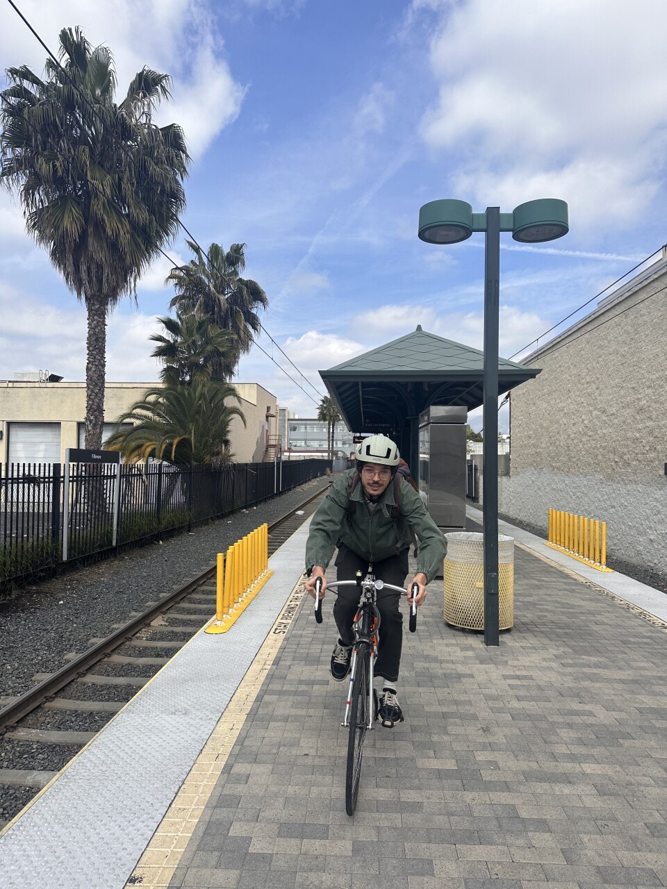 A fair skinned man rides his bike. 