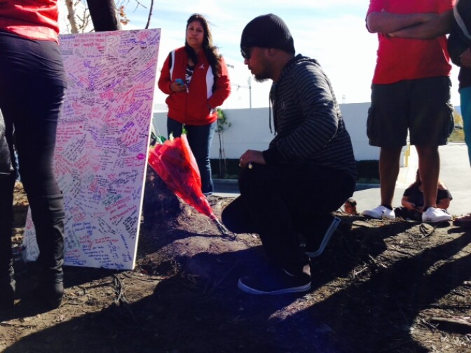 Fans of actor Paul Walker sign a message board at the scene of the crash that killed him and friend Roger Rodas.