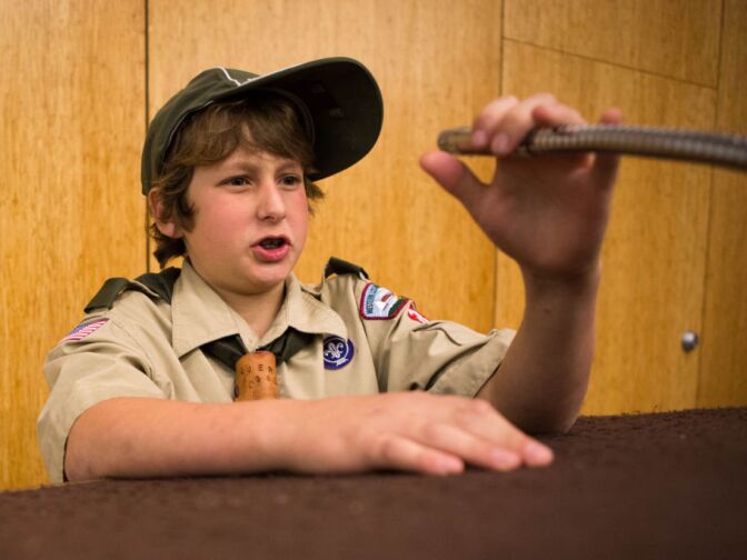 Jerry Pellman, 13, gives an extemporaneous speech on his way to a public speaking merit badge during a scout meeting.