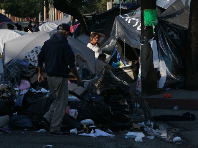 Tijuana, BAJA CALIFORNIA, Mexico - December 16, 2018.  At the Benito Juarez Sports Complex near downtown Tijuana,  Maria Isabel Reyes, 40, center, stands amid the garbage and migrant tents.


In Tijuana, Mexico, children members of the migrant caravan are learning to live in limbo as they move between shelters, settling in as much as possible to create a sense of normalcy, with help from NGOs, counselors and aid organizations. (Photo by Peggy Peattie)