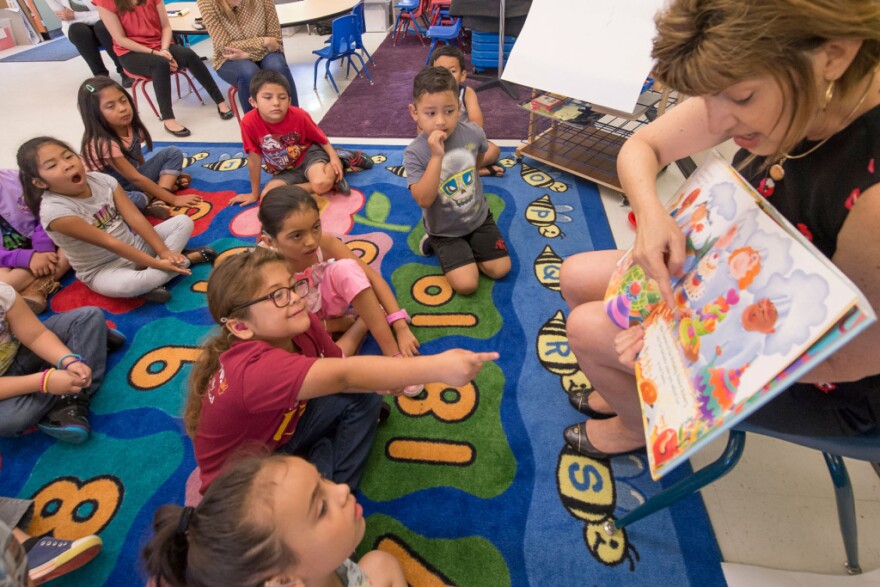 Debra Schrader, Education Specialist runs a dialogic reading exercise as part of the innovative "Come Read With Me" USC Program that helps develop literacy for deaf and hard of hearing children from bilingual families, July 21, 2016. (USC Photo/Gus Ruelas)
