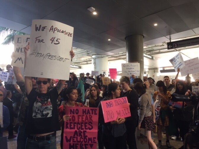 Protesters gathered at LAX on Sunday at Bradley International Terminal to protest President Trump's executive order temporarily banning migrants from 7 Muslim-majority countries.