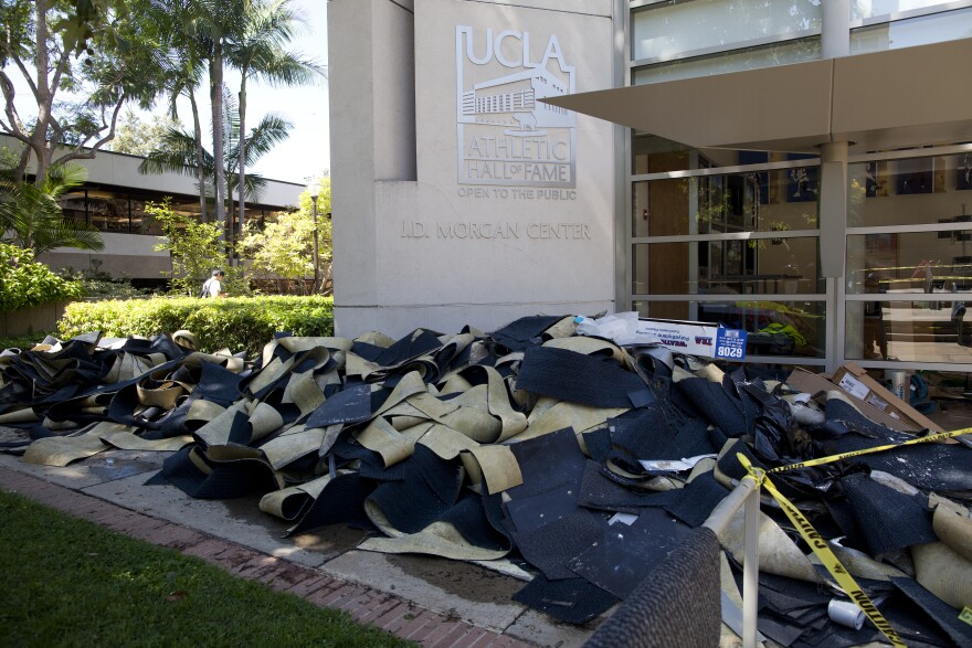 Waterlogged mats are piled up outside of the UCLA Athletic Hall of Fame a day after a ruptured water main on Sunset Boulevard flooded parts of the campus.