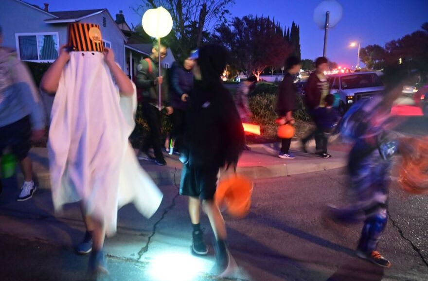 Children go trick or treating on Halloween night in Monterey Park, California on October 31, 2019. - Halloween is a major event for the American economy, from costumes and candy to lighting and decorations, with total spending forecast to reach 8.8 billion in 2019. (Photo by Frederic J. BROWN / AFP) (Photo by FREDERIC J. BROWN/AFP via Getty Images)