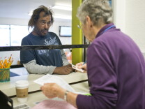 Tony Uribe turns in paperwork to get financial assistance at Share our Selves in Costa Mesa on Friday morning, May 29, 2015. Financial assistance is one of many homeless support services that require an identification card.